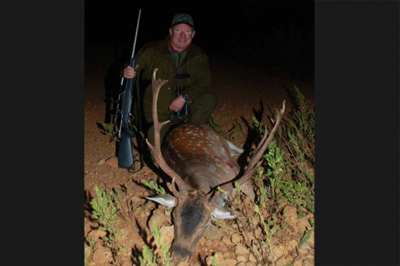 Hunter with fallow buck