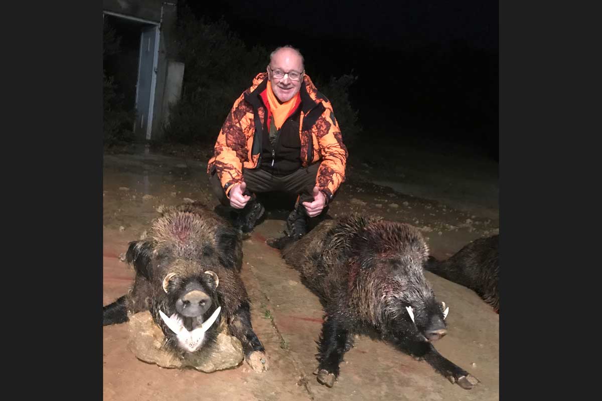 Hunter with two medal trophies, wild boar - keilers